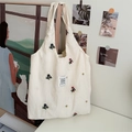 Beige canvas tote bag with colorful flower embroidery and a rectangular cloth label - Apricot Floral