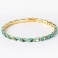Gold chain bracelet with rectangular blue zircon gemstones on white background - Aquamarine Zircon Gold
