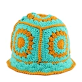 Close-up of handmade crochet bucket hat with vibrant floral patterns and wavy brim texture - Green