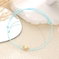 Bracelet tressé bleu clair ajustable avec pendentif cœur doré sur décor de pierre - Bleu clair
