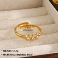 Adjustable golden stainless steel ring with three clear zircons in a jewelry box - Triple Stone Band