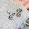 Detailed close-up of water drop cubic zirconia clip-on earring with soft silicone pad - Clip-On Earrings / White