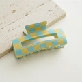 Macro detail of the square blue and yellow checkered hair claw clip on stone - Hollow Green Yellow