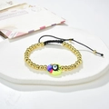 Detailed shot of handmade woven bracelet with gold beads and colorful evil eye heart charms - Dark Blue Heart