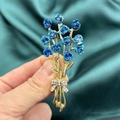 Elegant gold-tone brooch featuring blue enamel roses and a sparkling rhinestone bow - Blue Rose