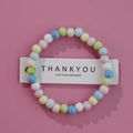 Handmade ceramic beaded bracelet with pastel macaron colors on a soft pink background - 1586-14 Macaron Round Beads