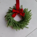 Mini Christmas wreath with green pine needles and a classic red velvet bow ornament - Red Velvet Bow Lanyard Wreath