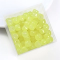 Macro detail of translucent pale yellow cylindrical glass beads for DIY jewelry making - Yellow