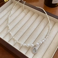 Detail of silver chain necklace with pearls and a teardrop blue gemstone pendant - 12# Necklace-Silver-Drop
