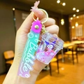 Macro shot of Kuromi bubble tea keychain with purple liquid and floating glitter charm - Gradient Strap Heart Cup White Character