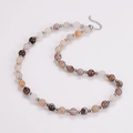 Detail of earth-tone agate beaded necklace with silver spacers and lobster clasp chain - Necklace / Steel