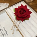 Detailed macro view of red velvet rose hair clip with golden pearl tassels on display - Duck Clip-Red