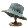 Retro washed blue denim bucket hat with fringe edges on a wooden display stand - One Size / Blue 3