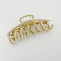 Detailed view of the gold alloy hair claw clip featuring a unique hammered metal texture - Gold