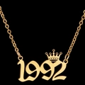 Golden 1992 lucky year pendant necklace with crown detail on a black background - 1992 / Gold