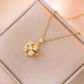 Macro view of gold flower pendant with small diamonds and a center pearl on a box - X0193 Pearl Windmill