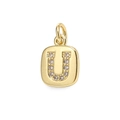 Macro shot of gold square pendant with letter U inlaid with sparkling zircon crystals - Letter U