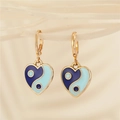 Macro detail of heart-shaped yin yang earrings with blue enamel in gold finish - Dark Blue Light Blue