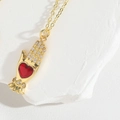 Gold hand-shaped pendant with red heart gemstone and zircon stones on a gold chain - Hand Holding Heart