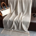Detailed texture of lightweight gold silk scarf with decorative gold edges on leather background - Apricot
