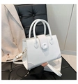 Detail of white square handbag with crocodile pattern texture on the flap and corners - White