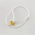 White braided rope bracelet with interlocking gold trinity rings on a stone surface - All Gold Rings White Rope