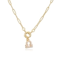 Close-up of gold Libra zodiac pendant with white pearl on paperclip chain necklace - Libra / Gold