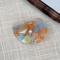 Close-up of orchid hair clip with gradient petals and a pearl center on linen - Mixed Colors