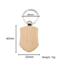 Macro view of shield-shaped beech wood keychain showing dimensions 42mm and 32mm - Shield Shape (Style 13)