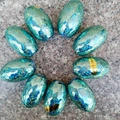 Teal holographic laser ribbons for balloon decoration, 7mm x 10m rolls on granite surface - Holographic / Light Blue