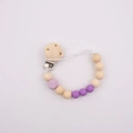 Detail of wooden baby pacifier clip with purple silicone beads on white background - Purple