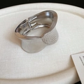Detailed macro of silver irregular cuff bracelet featuring a mixed smooth and hammered texture - Silver