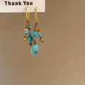 Detail of ethnic fish shell tassel earrings with turquoise beads and gold hooks - 925 Sterling Silver Earring Post Gold Turquoise Tassel