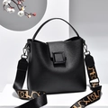 Elegant black leather handbag with a patterned wide strap and square metal lock detail - Black Litchi Pattern