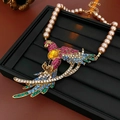 Dettaglio del ciondolo a pappagallo con strass colorati e gemma gialla su collana di perle - Collana di Perle di Pappagallo Multicolore