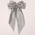 Close-up of elegant silver grey satin bow hair clip with smooth silk texture and soft sheen - Gray