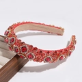 Detail of red gemstones and clear rhinestones on luxury gold headband accessories - Red