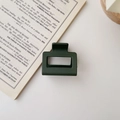 Detail of square hollow hair claw clip in matte dark green on a vintage book - Matte Dark Green