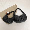 Two black quilted puffy dumpling bags in different sizes on white fabric background - Small / Black