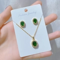 Detail of emerald oval jewelry set with necklace and earrings in gold finish - Gold Emerald Stone Set (Q)