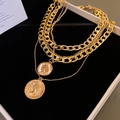 Macro detail of multi-layer gold coin necklaces featuring vintage portrait relief on black velvet - Gold Portrait Coin Multi-layer Necklace