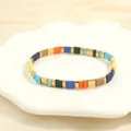 Detail of colorful Tila bead bracelet with gold squares on a white decorative tray - Morandi Multicolor-K