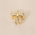Detailed view of a gold-plated bow pendant with sparkling cubic zirconia crystals - Full Zirconia Bow (PJ0263) / Gold