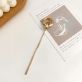 Gold metal hair pin with minimalist double interlocking rings on an aesthetic background - Hoop Style