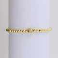 18k gold beaded elastic bracelet featuring a sparkling diamond-set square letter V pendant - Letter V