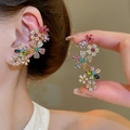 Macro shot of 18k gold plated flower ear cuff with colorful rhinestones on a model - Gold-Colorful Flower Cluster (82# Silver Earring Post)