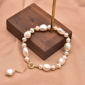 Baroque natural pearl bracelet with 18k gold plated clasp on walnut display stand - Two-Sided Smooth Graduated Size Freshwater Pearl Bracelet