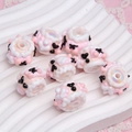 Macro shot of handmade sheep-shaped pink and white resin beads for DIY jewelry crafts - Price per Piece / White Bead Pink White Cream + Cherry