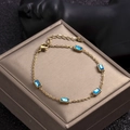 Gold-plated stainless steel bracelet featuring five rectangular blue zircon stones - Blue Zirconia