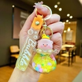 Detailed shot of cute pink pig in yellow liquid oil bottle keychain with star strap - Gradient Rope [yellow] Glow-in-the-dark Pvc Peach Pig